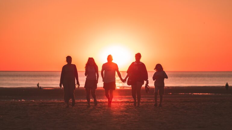 People holding hands on a beach