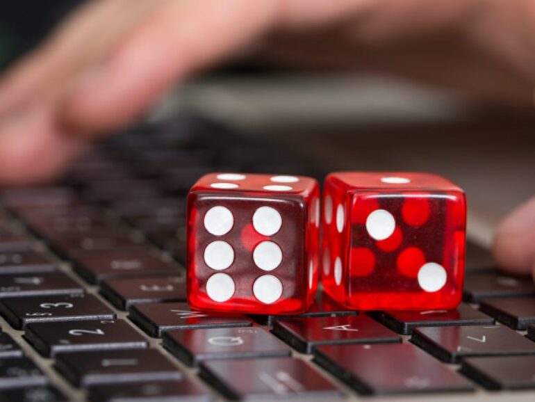 Dice on the laptop. Depiction of Online Casino