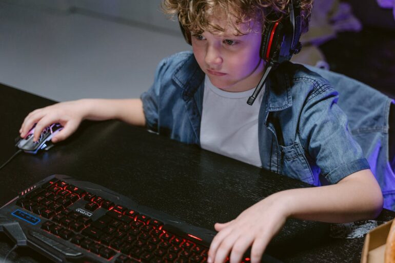 Boy with headphones playing video games