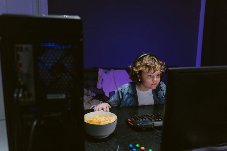 Boy with headphones playing video games