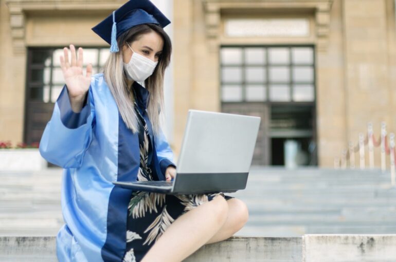 Woman Sitting in A College Graduation Uniform with A Laptop in Her Lap. Concept for Online Degree