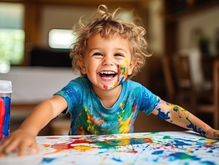 smiling young boy with bright paint on his hands and body, ai generated, smile child, colorful washes, playful and colorful depictions, oyful chaos, hand-coloring, joyful chaos, colorful portrait