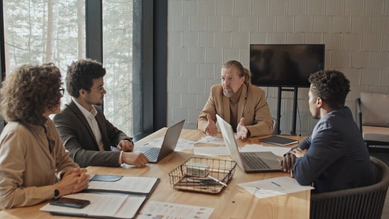 Business team in a formal meeting discussing contracts across borders