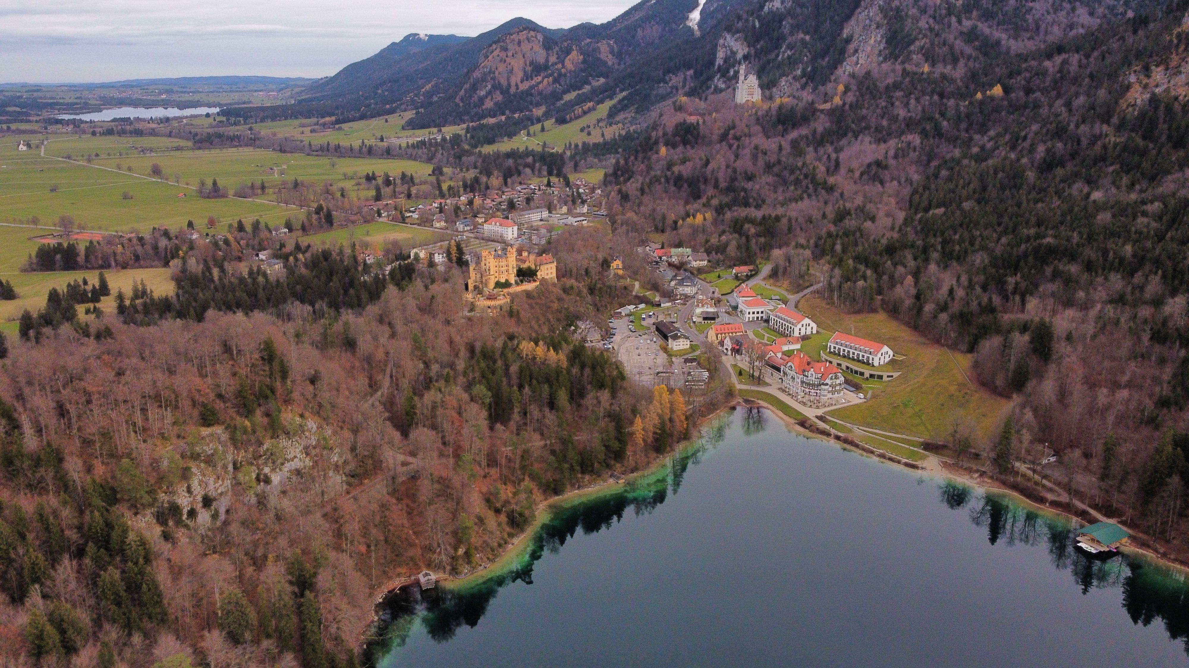 Aerial view of Neuschwanstein and Hohenschwangau castles surrounded by Bavarian forest and lake
